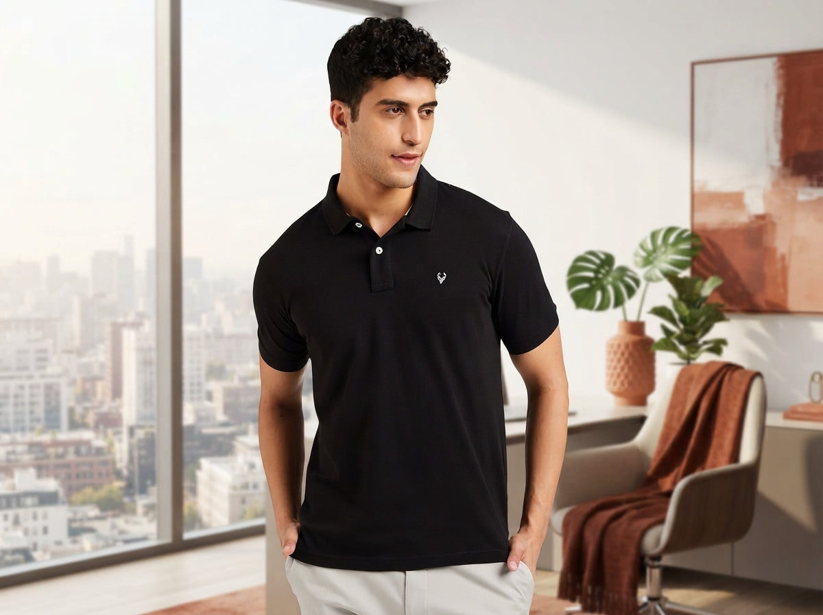 A South Asian man wearing a crisp polo shirt in a modern office, representing effortless style from work to evening.